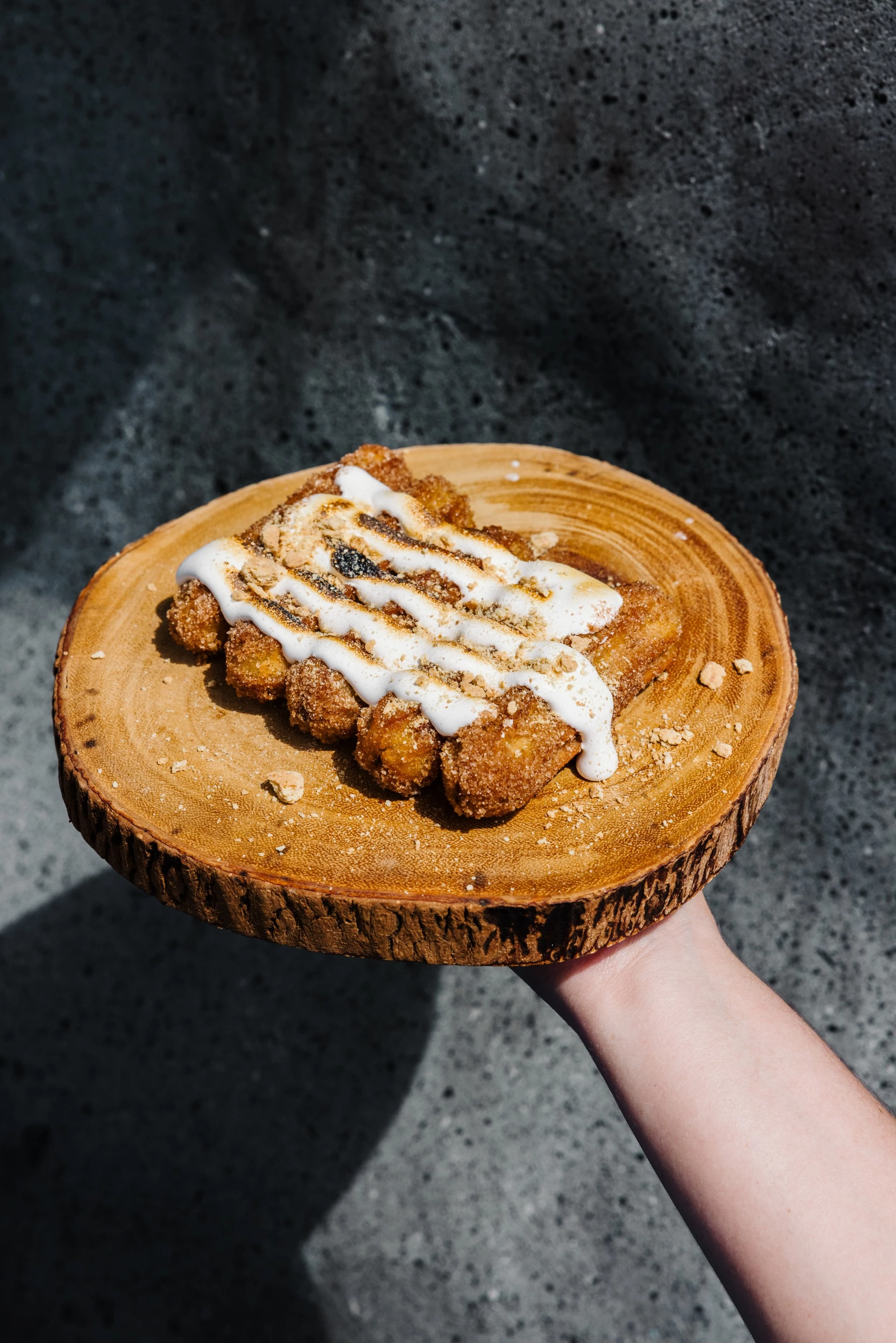 a hand holding a plate of food