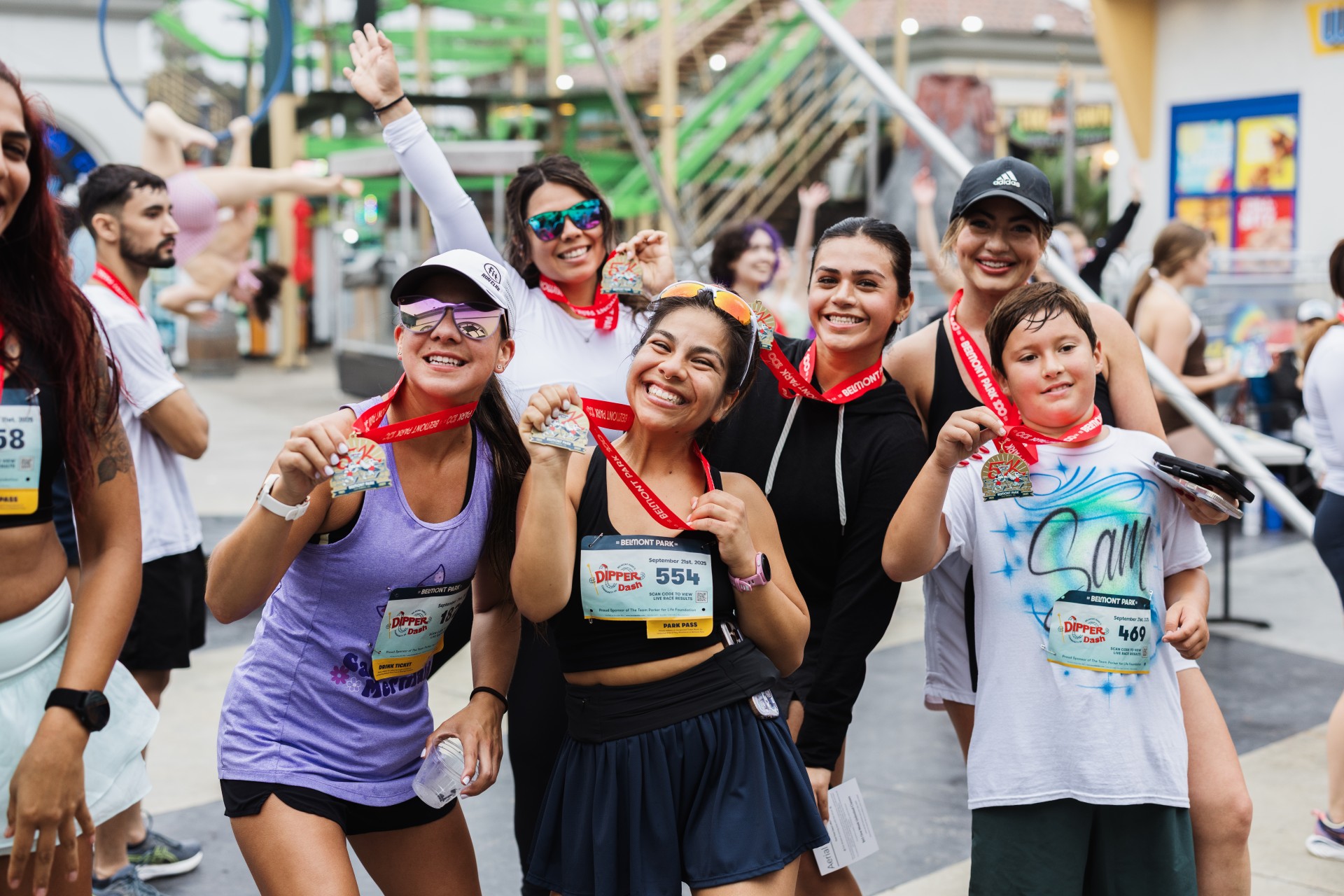 a group of people posing for a photo at the dipper dash 5k