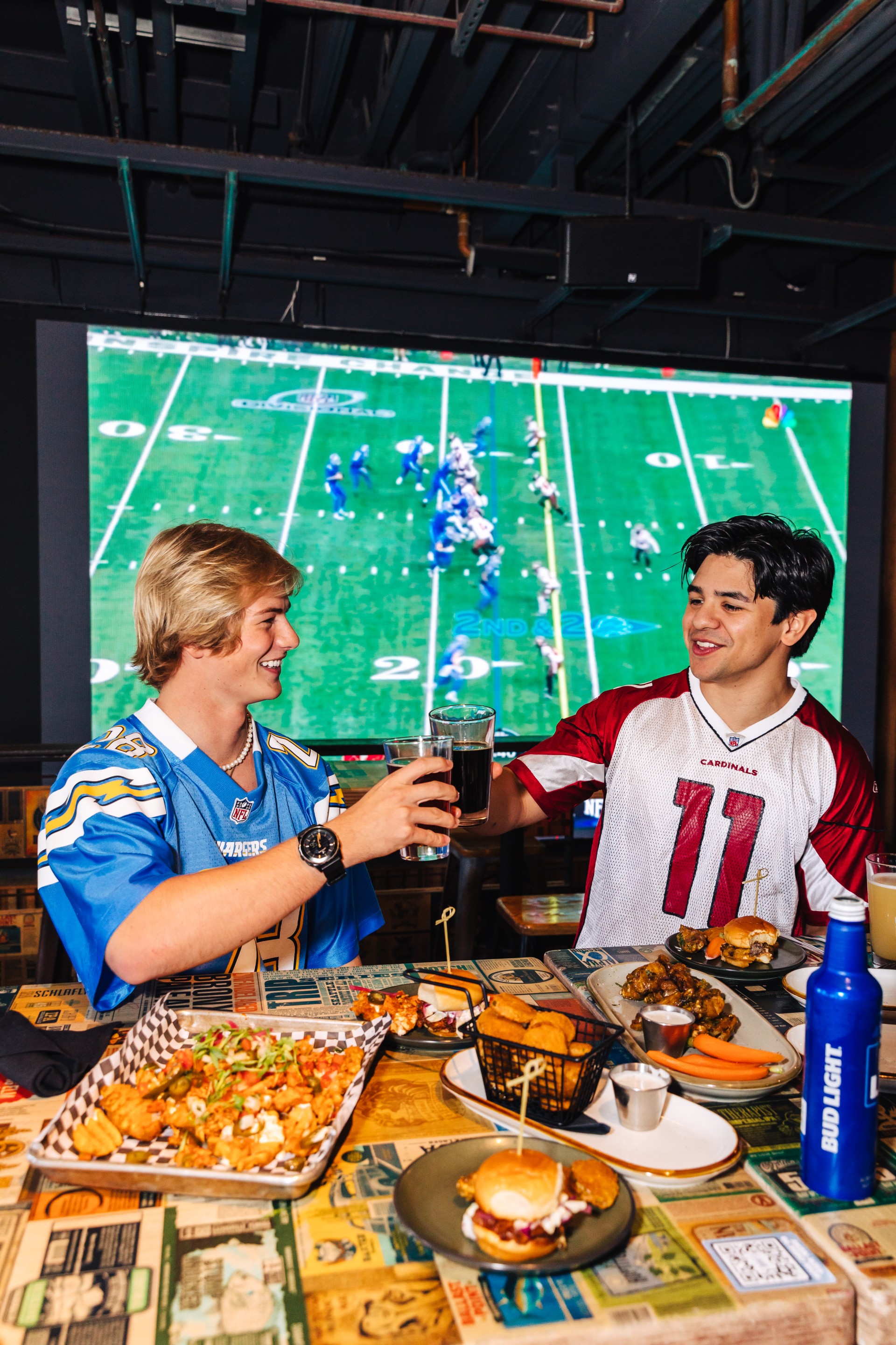 two men drinking beer and eating food