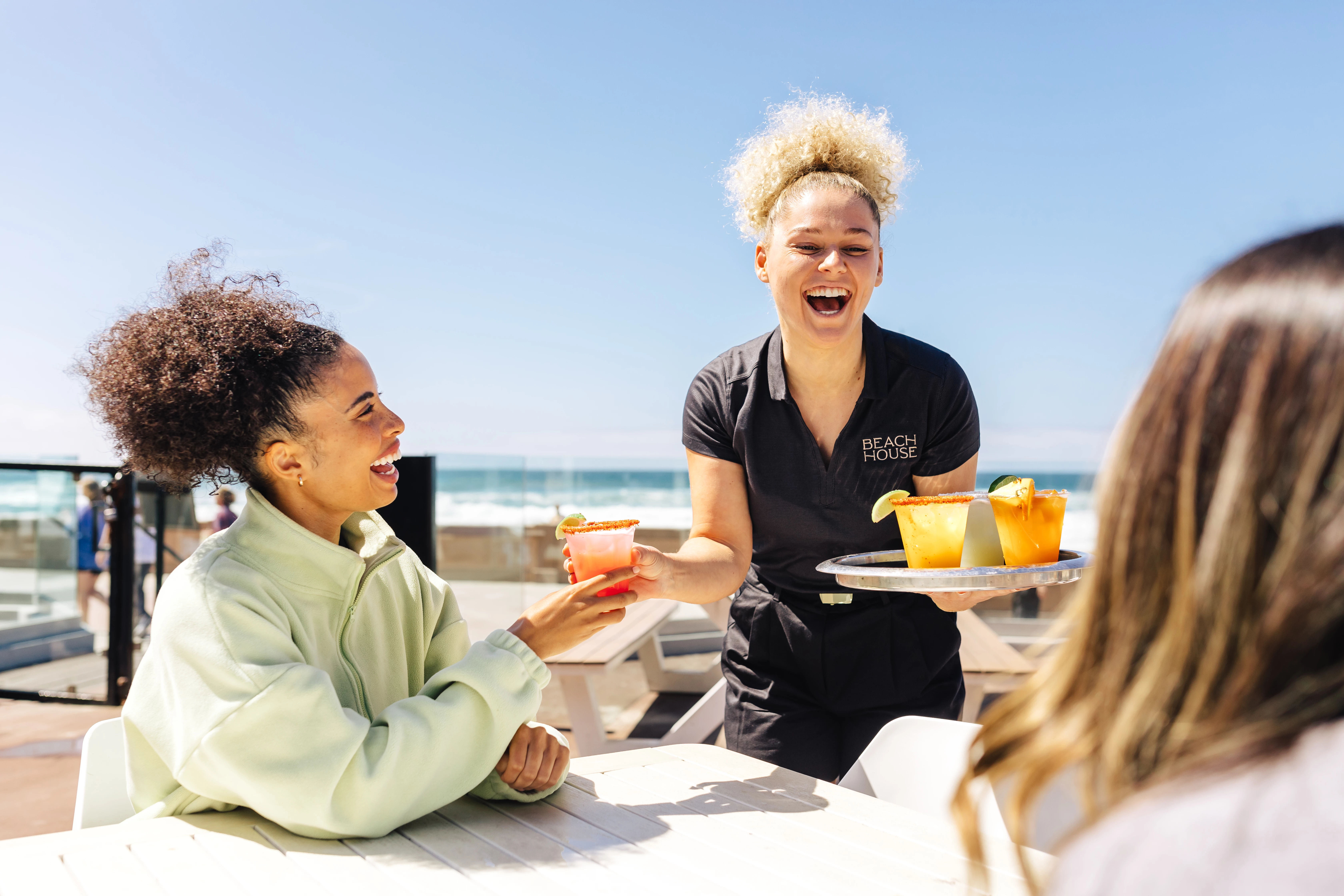 a group of women sitting at a table with drinks