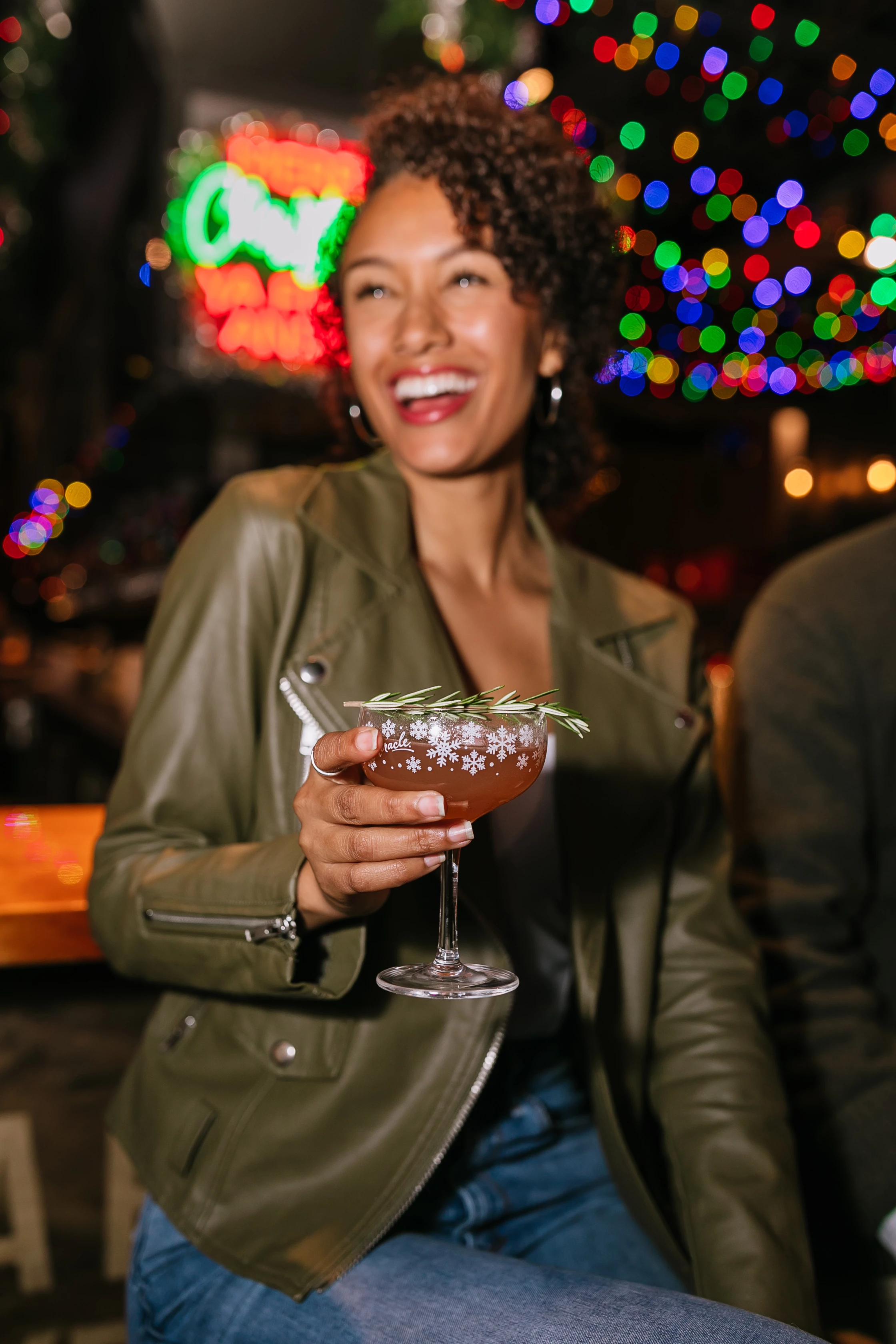 a woman holding a drink