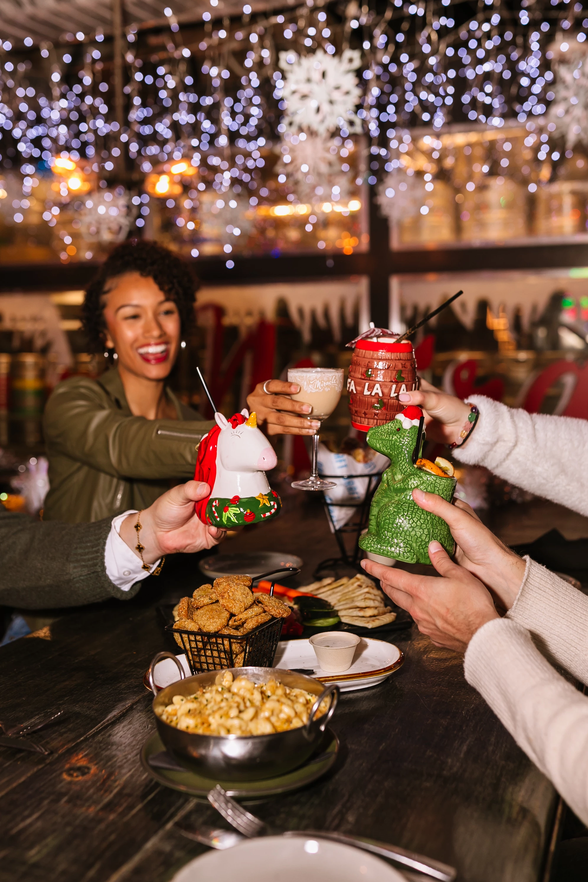a group of people clinking glasses with drinks