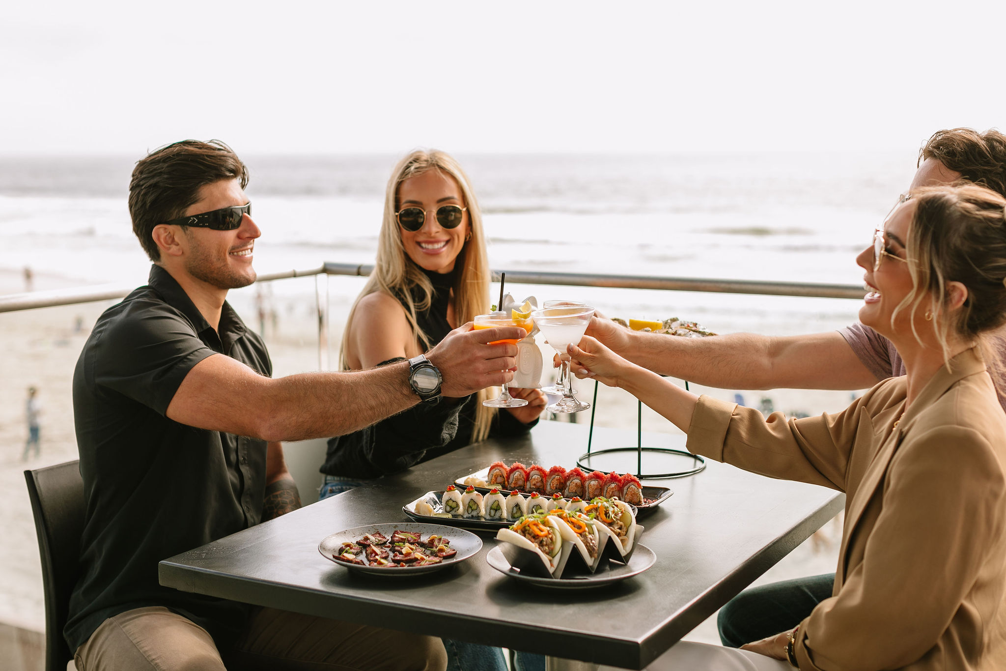 a group of people sitting at a table with food on it