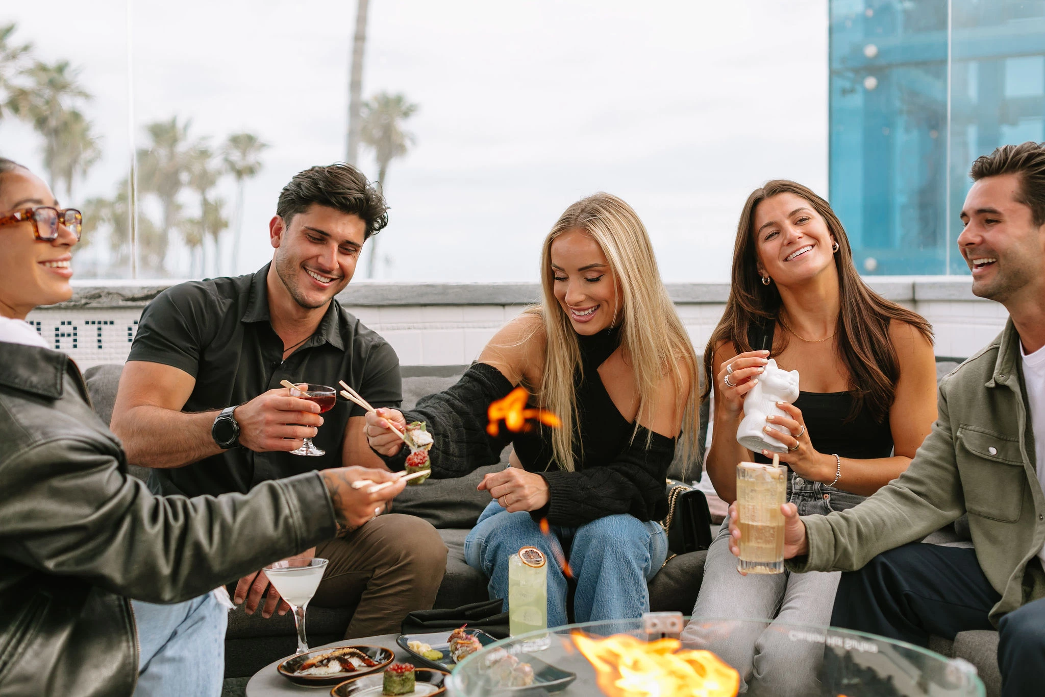 a group of people sitting around a fire