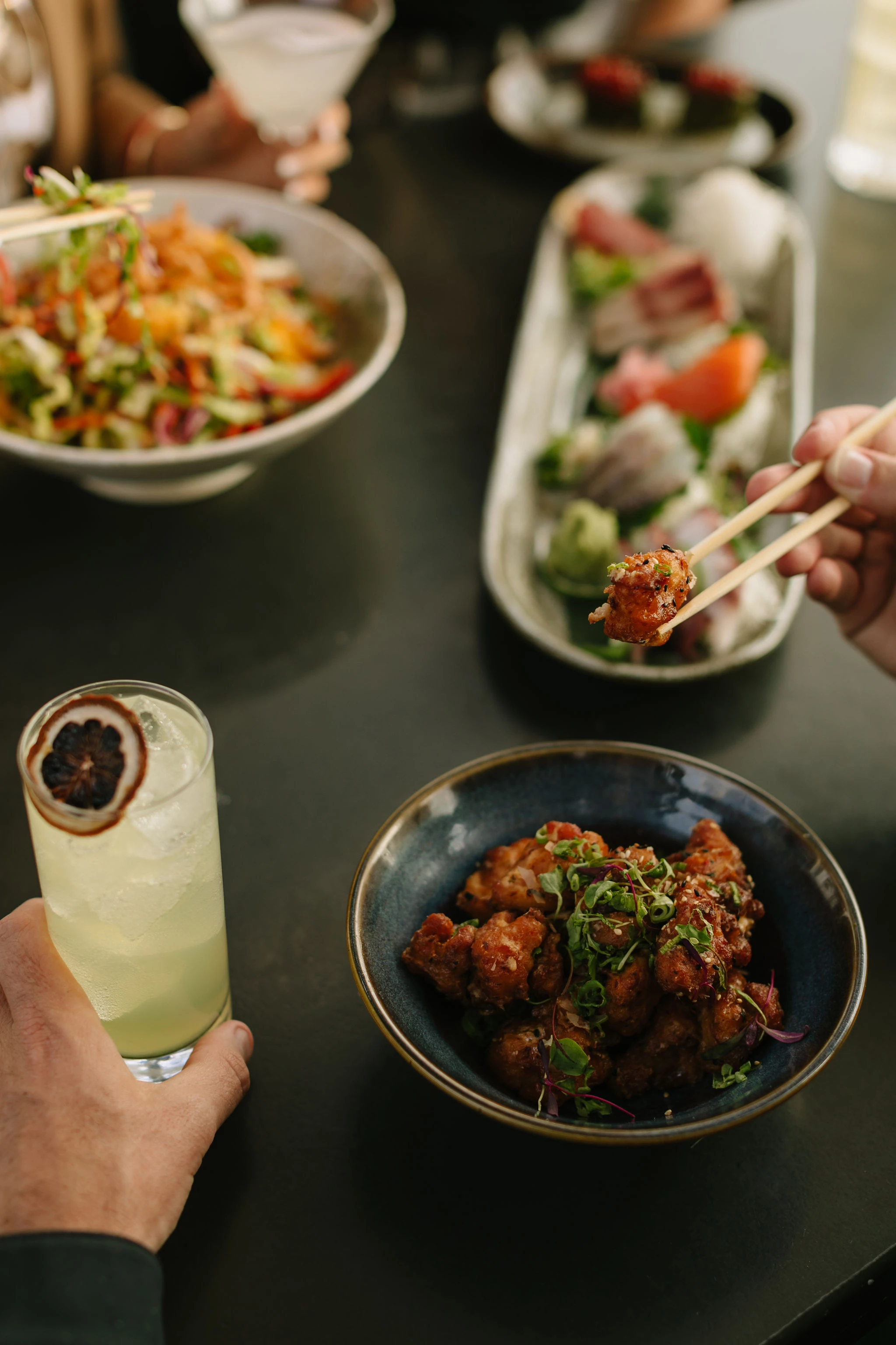 a person holding chopsticks and a bowl of food