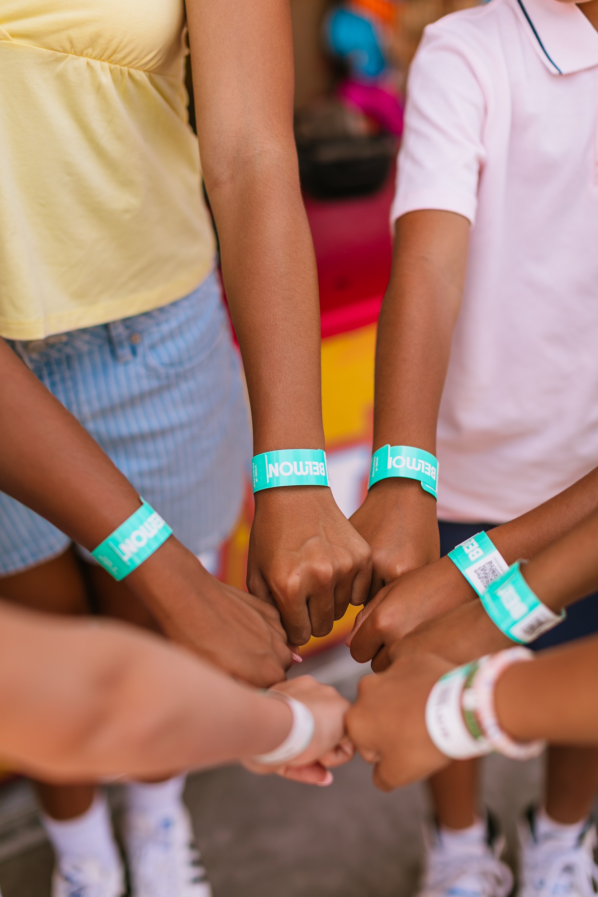 a group of people putting their hands together