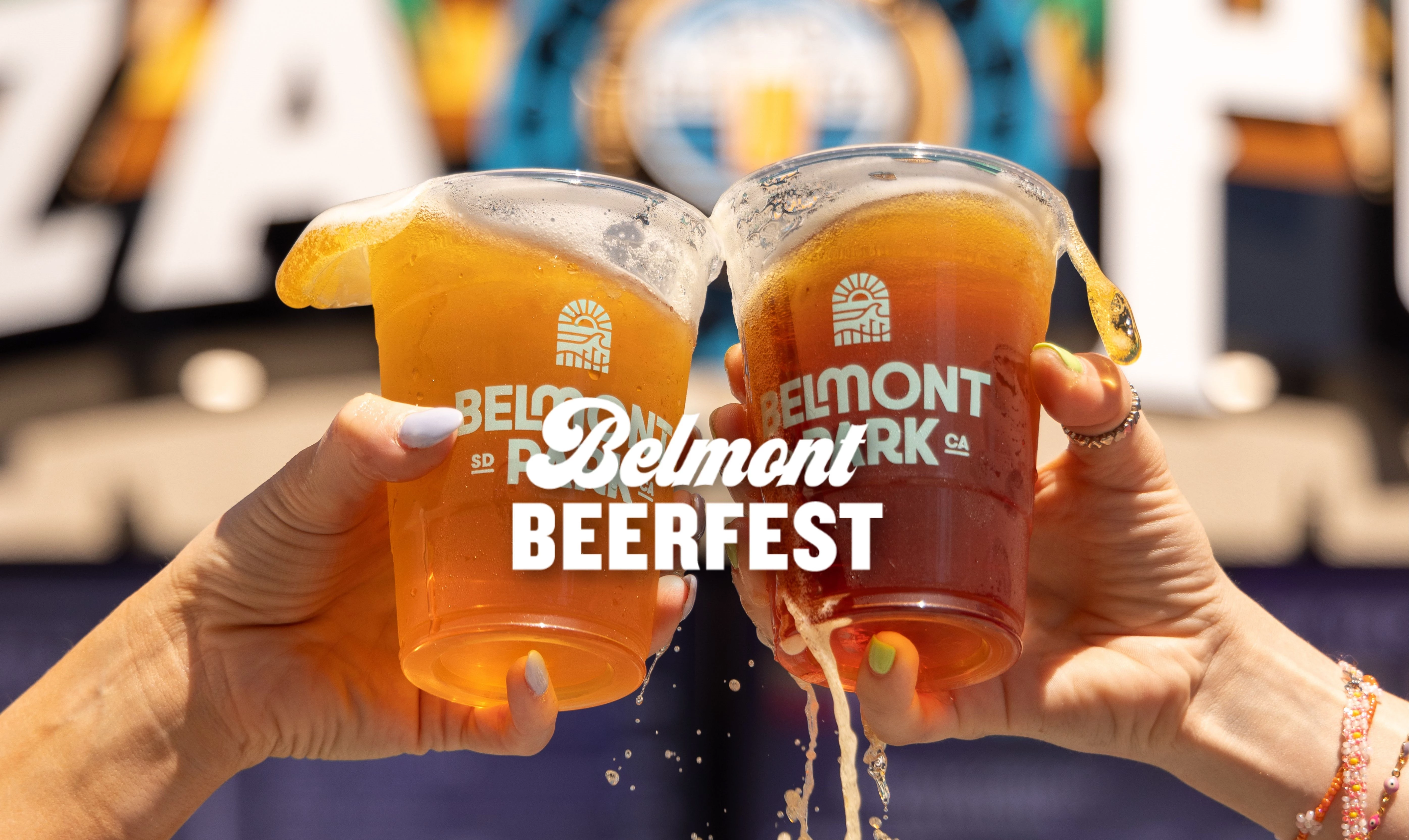 a pair of hands holding up two cups of beer
