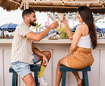 a man and woman sitting at a bar