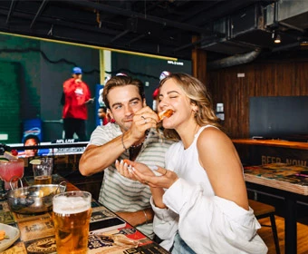a man and woman eating pizza