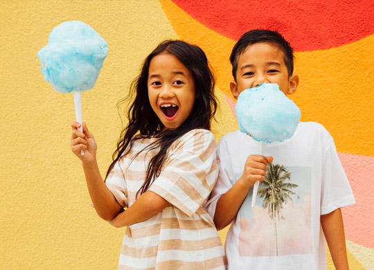 a couple of kids holding cotton candy