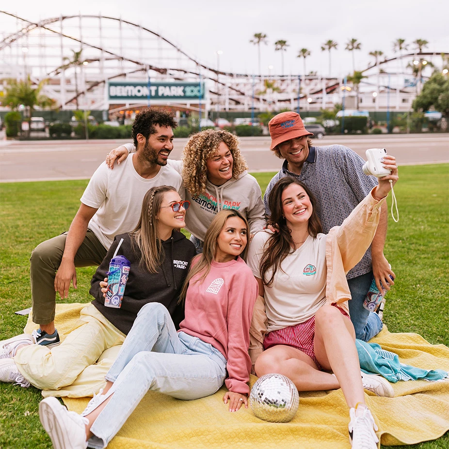 a group of people sitting on a blanket
