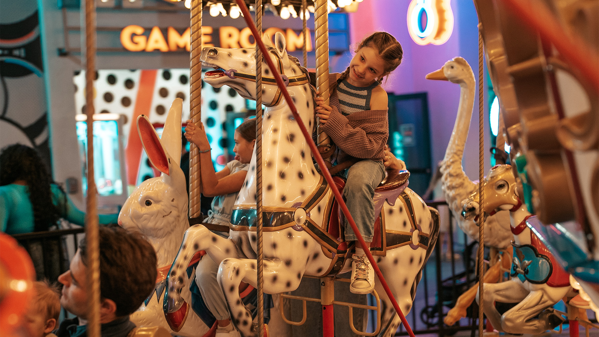 a girl riding a carousel