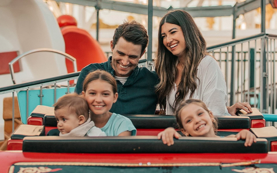 a man and woman with children on a ride