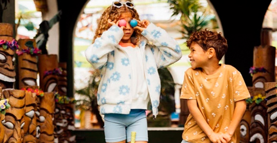 a girl holding a ball to her eyes