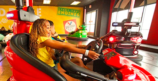 a group of kids driving bumper cars