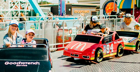 a group of people riding a toy car