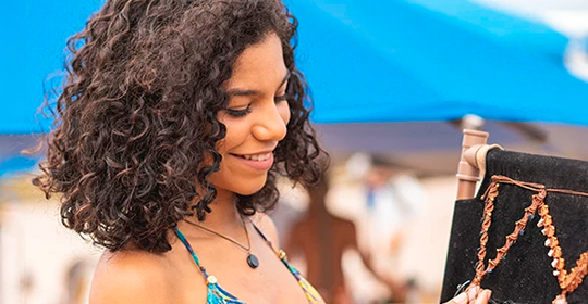 a woman in a garment looking at a cell phone