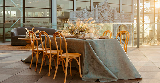 a table with a tablecloth and chairs