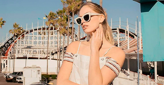 a woman wearing sunglasses and posing for a picture