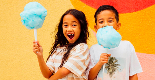 a boy and girl holding cotton candy