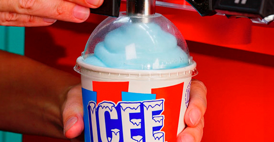 a person holding a container of ice cream