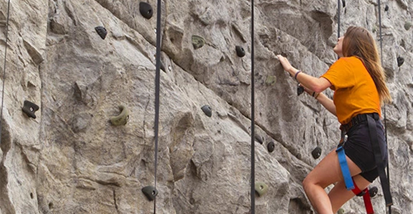 a person climbing a rock wall
