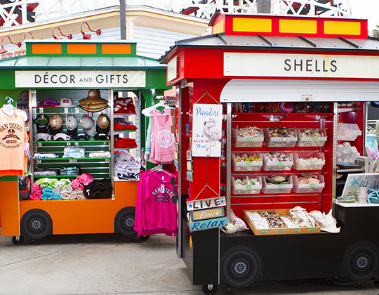 a small cart with food in front of a store