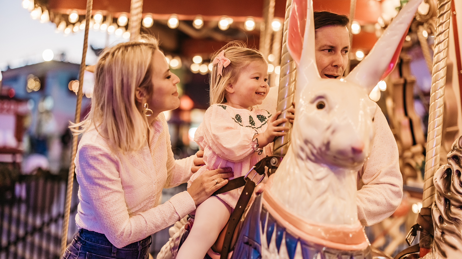 a woman and a child on a carousel