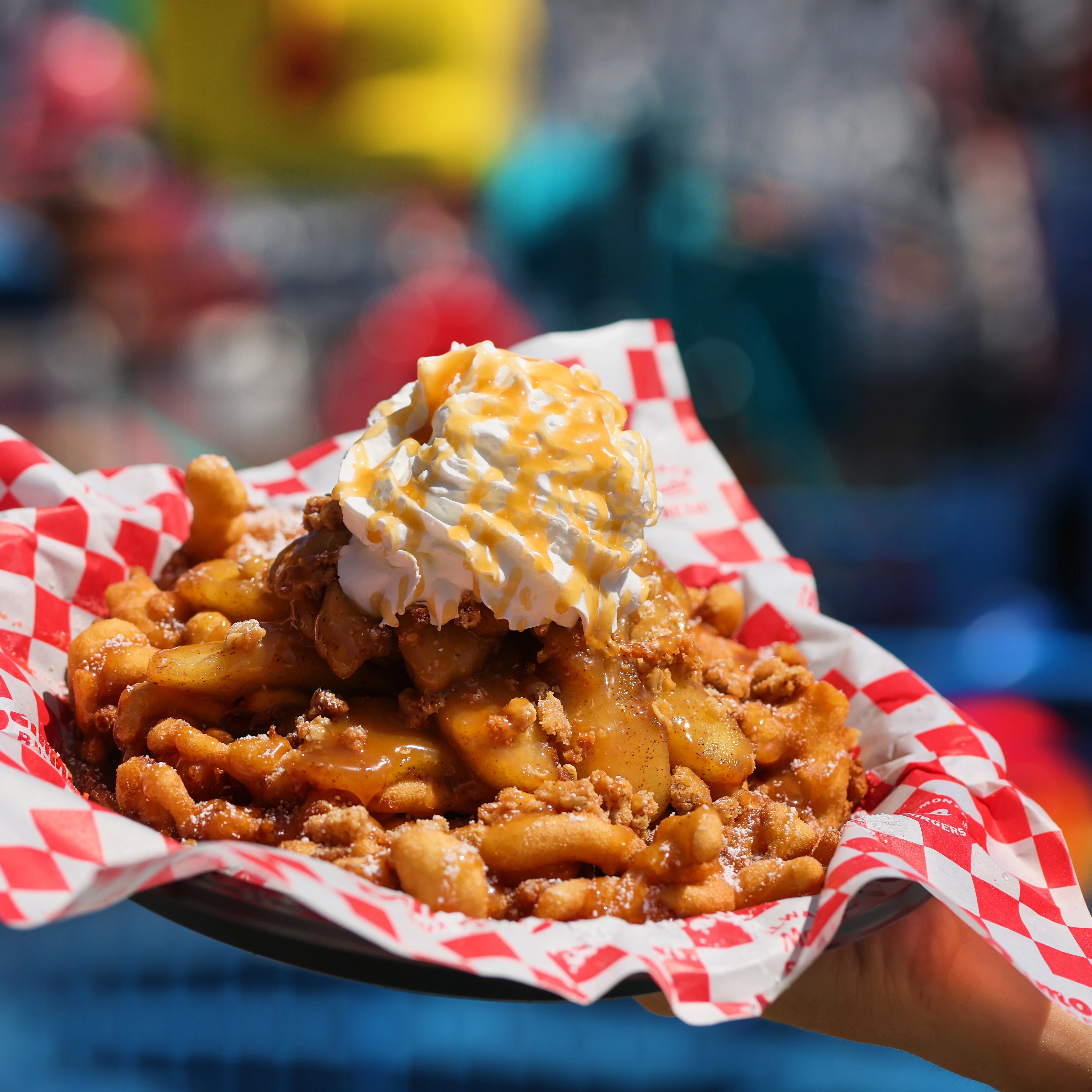 a plate of food with whipped cream and a blue fence