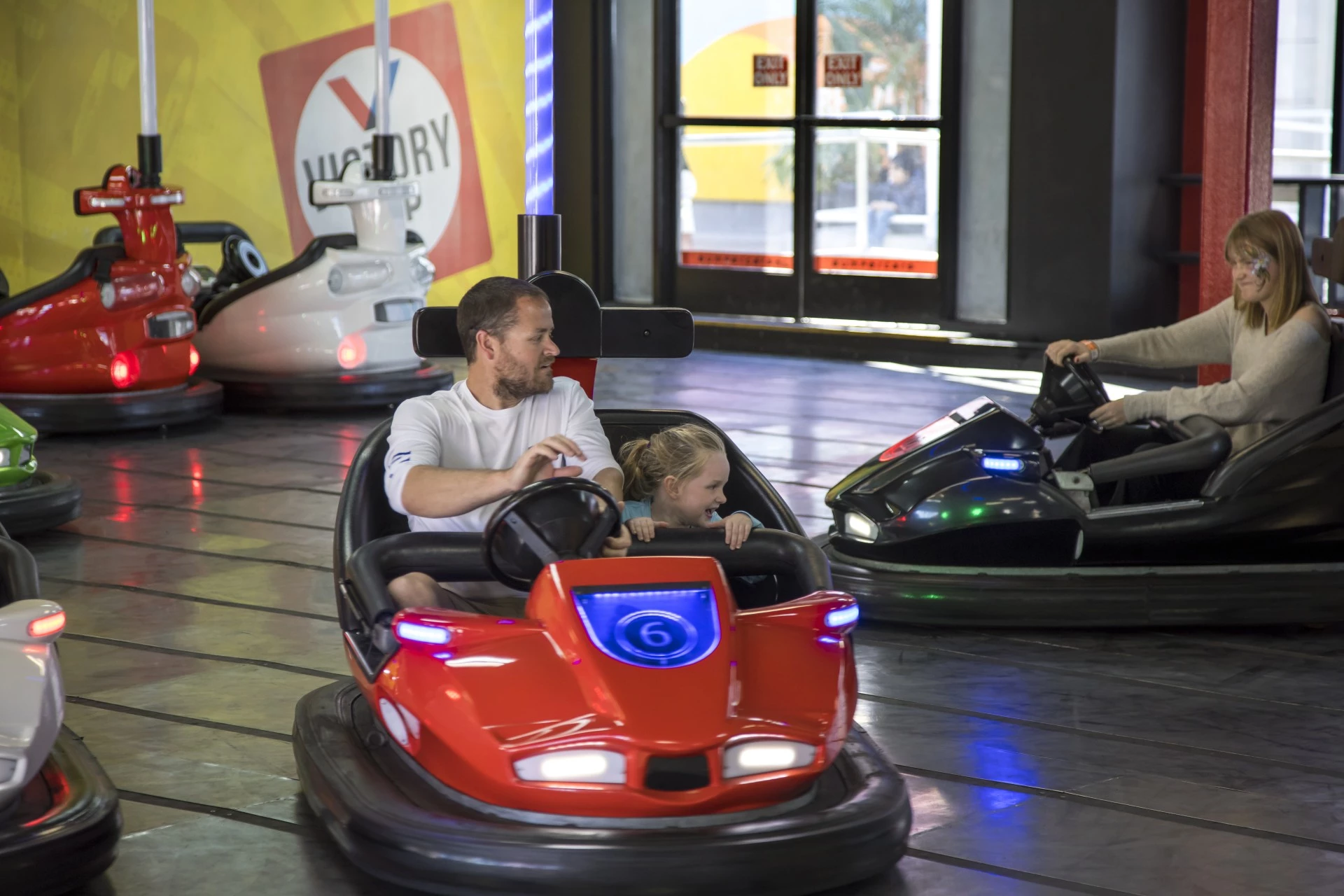 a man and a girl driving a bumper car