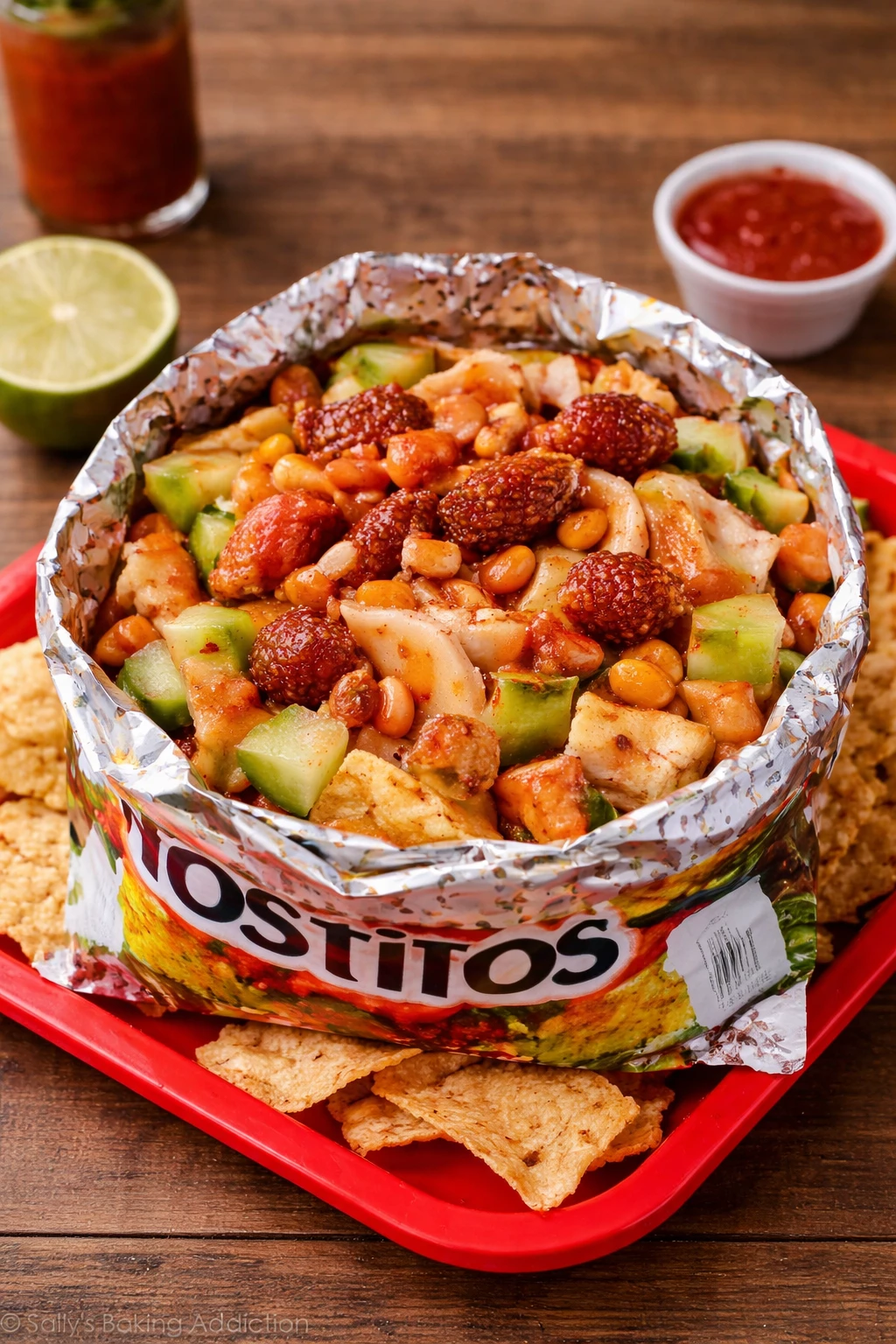a bowl of food on a tray, specifically Tostilocos