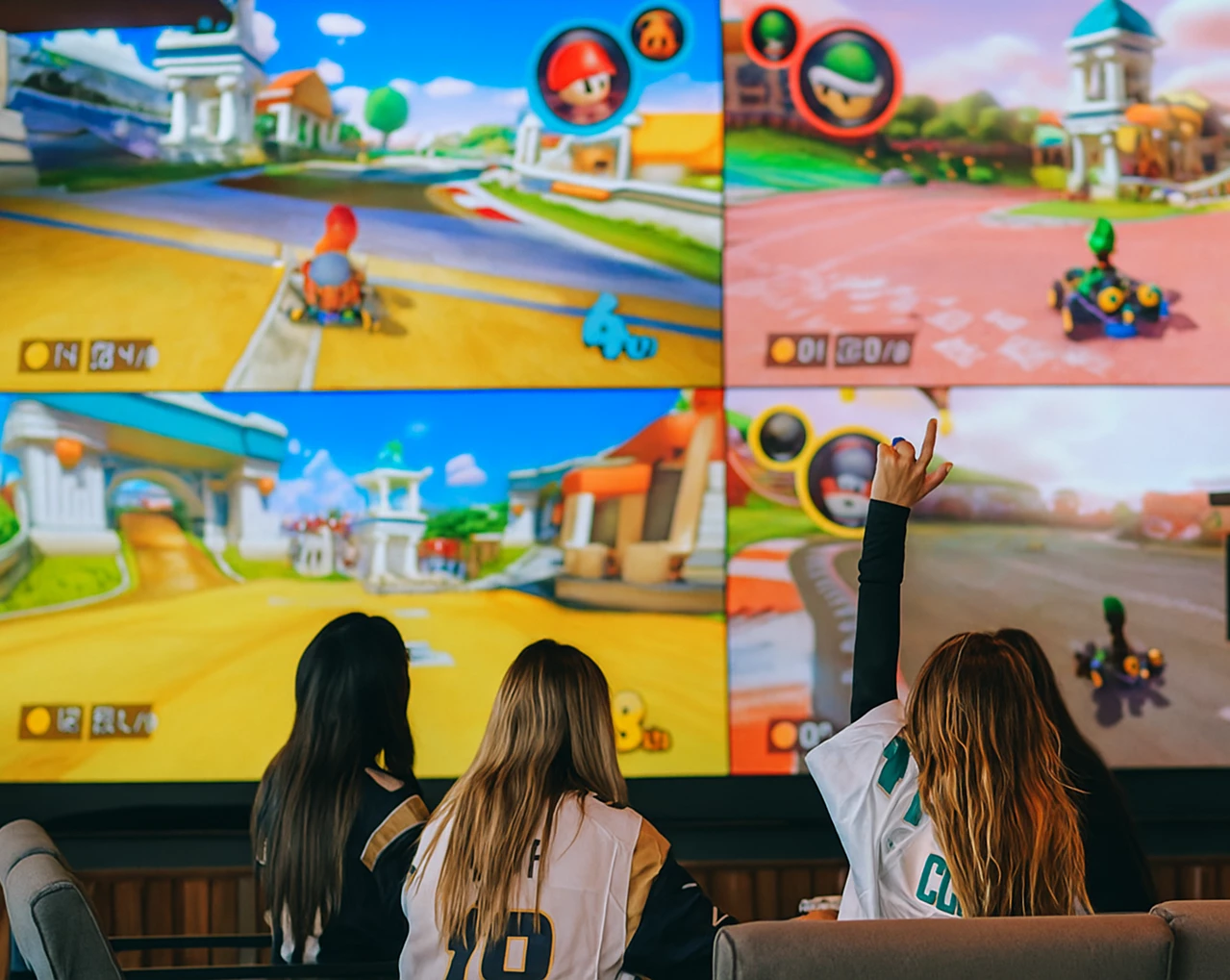 a group of women looking at a large screen