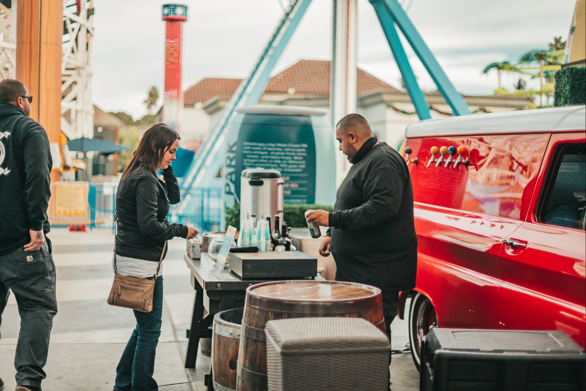 a man and woman standing next to a table with drinks