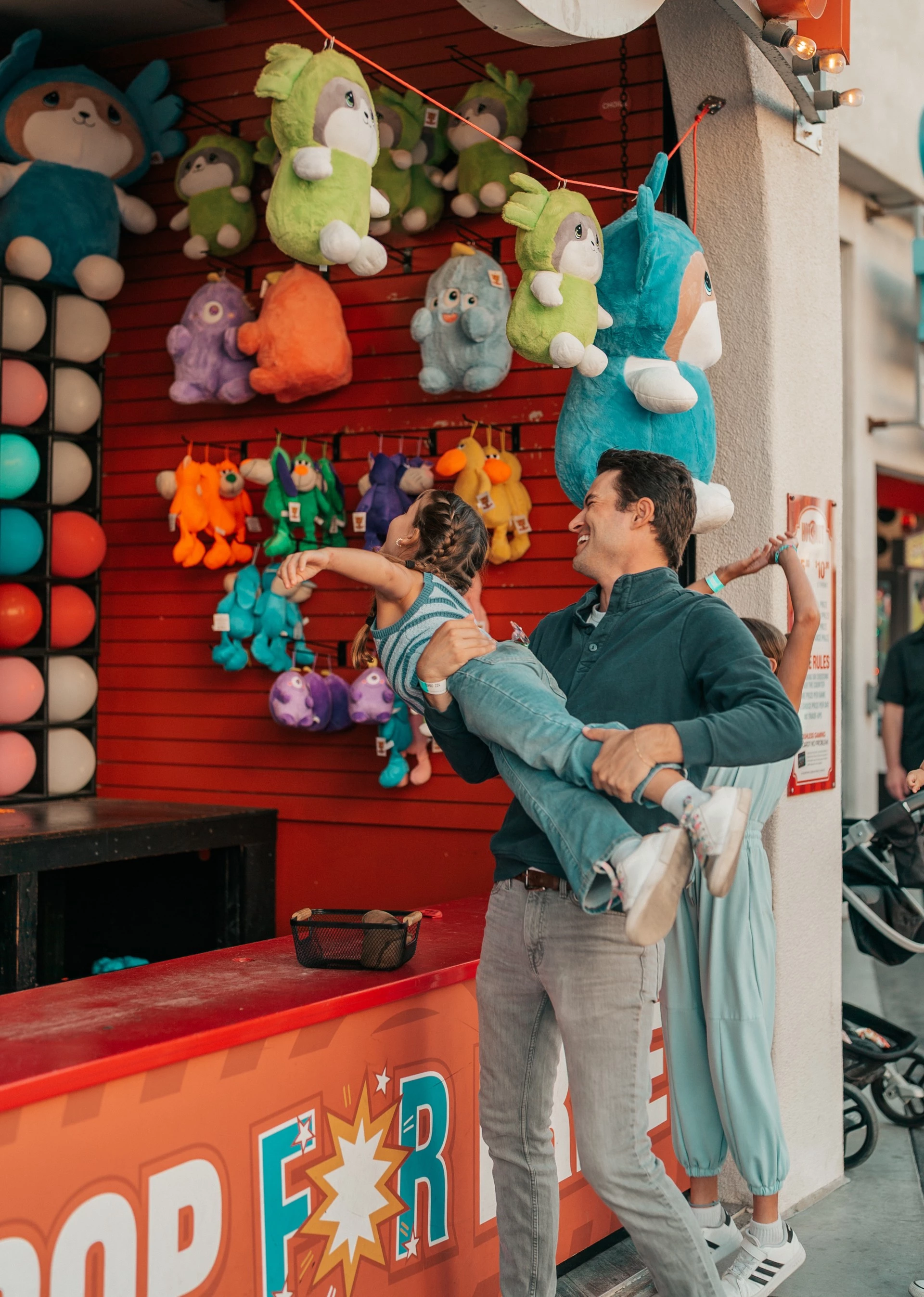 a man holding a girl in the air