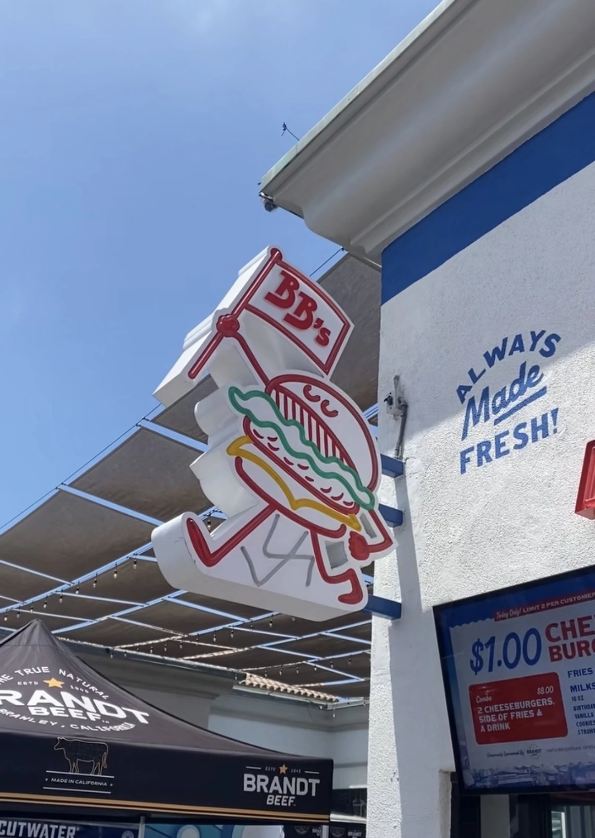 Belmonty's burger sign with a tent that says Brandt beef in the background
