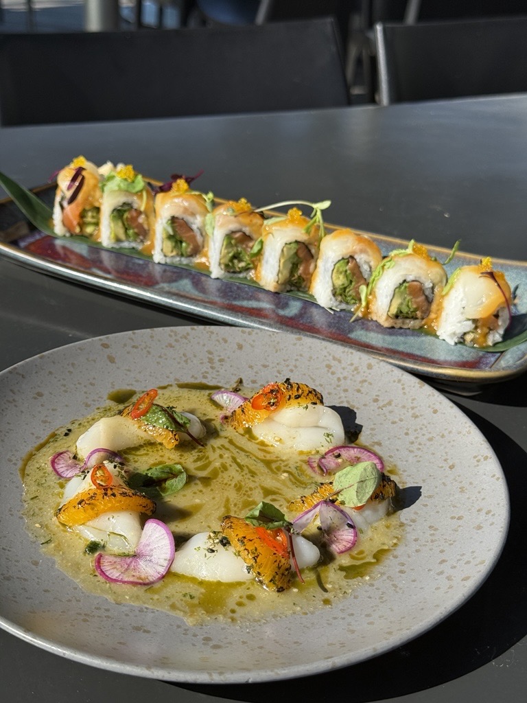 a plate of sushi (august nights roll) and a plate of scallop crudo