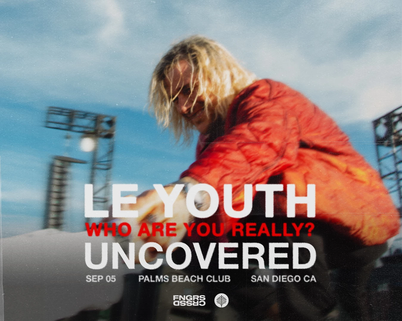 a man in a red jacket from band le youth