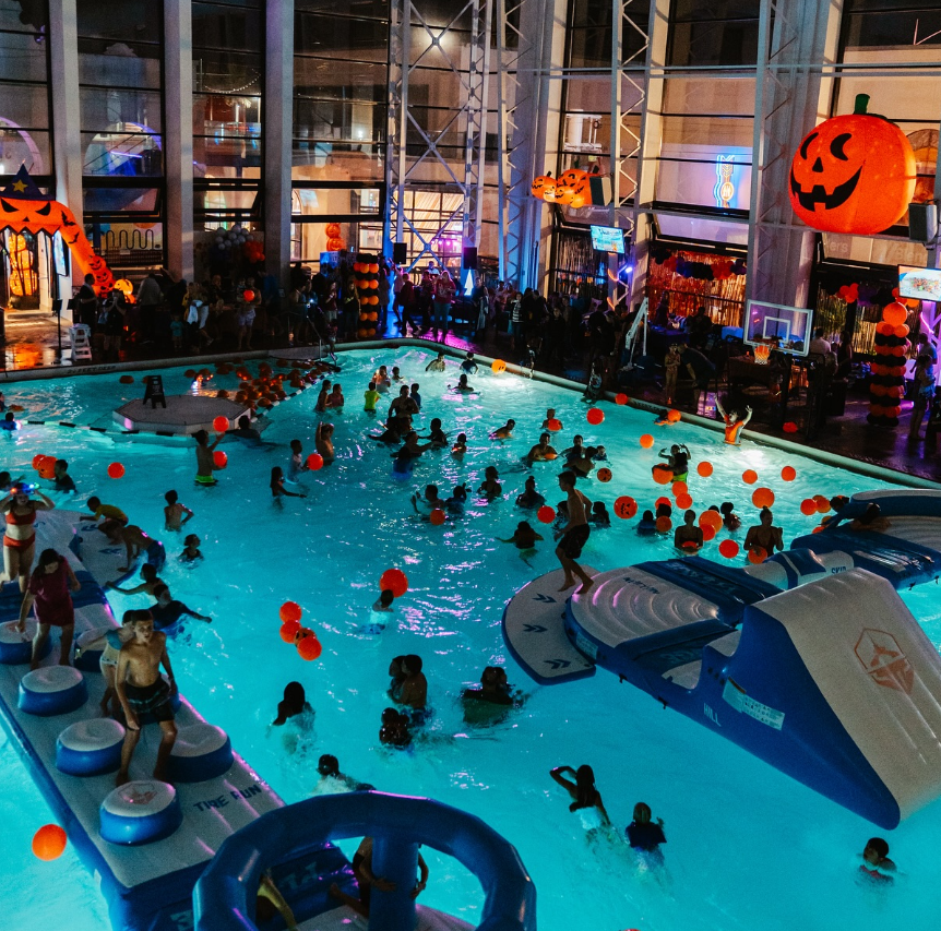 a large indoor pool with people in it