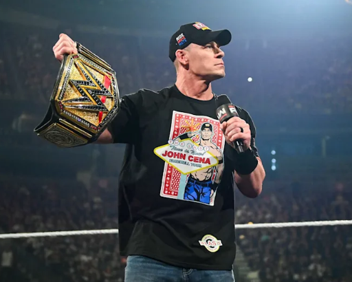 a man holding a microphone and a belt in a ring