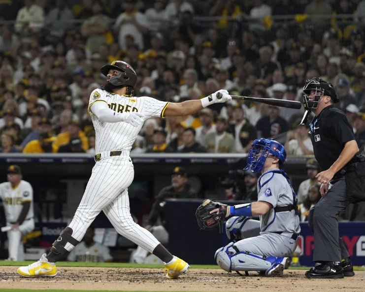 a Padres baseball player swinging a bat