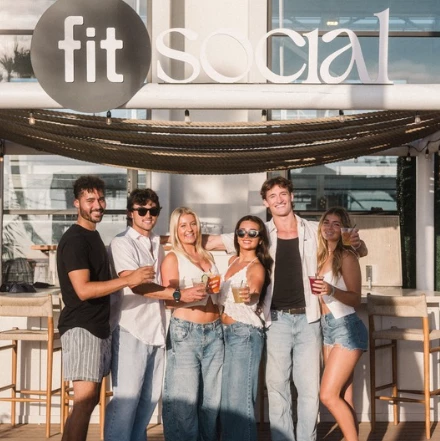 a group of people posing for a photo with drinks