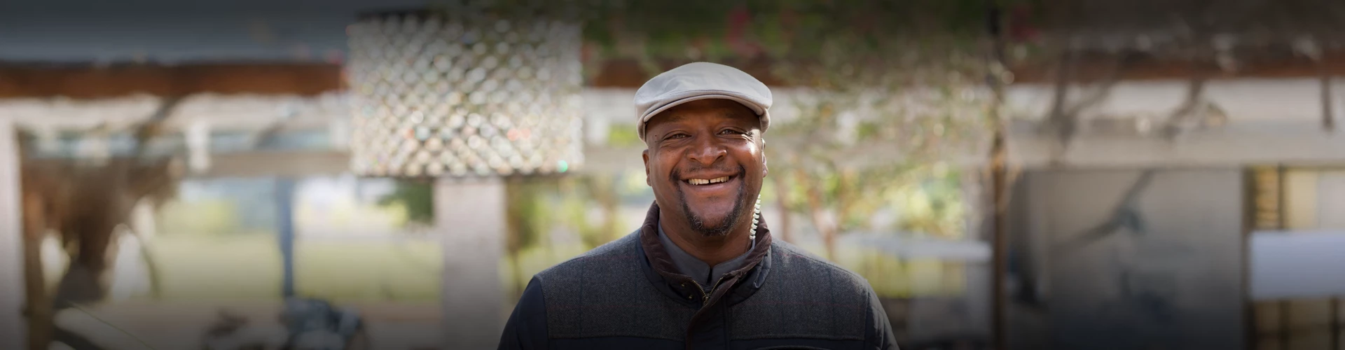 a man wearing a hat and a jacket