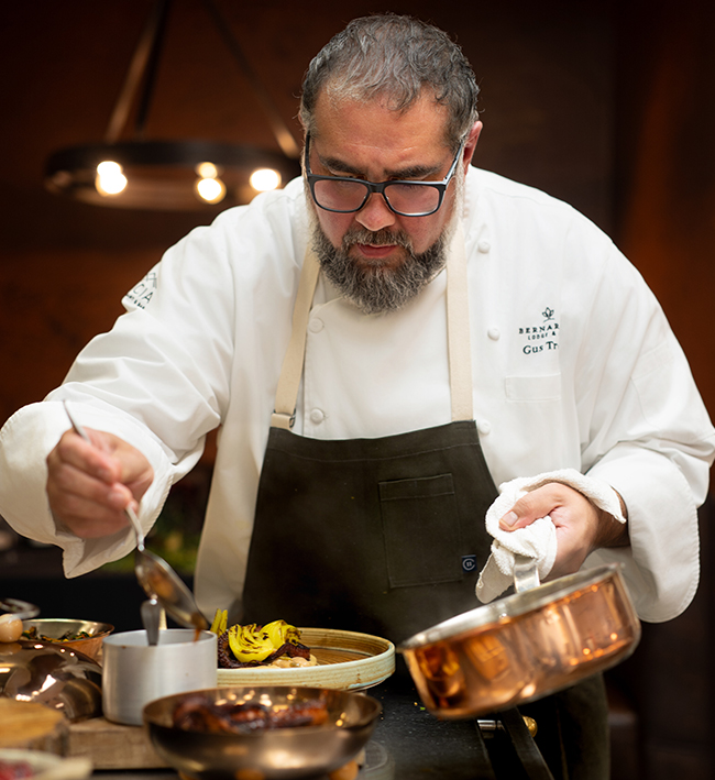 a man in a chef's uniform cooking food