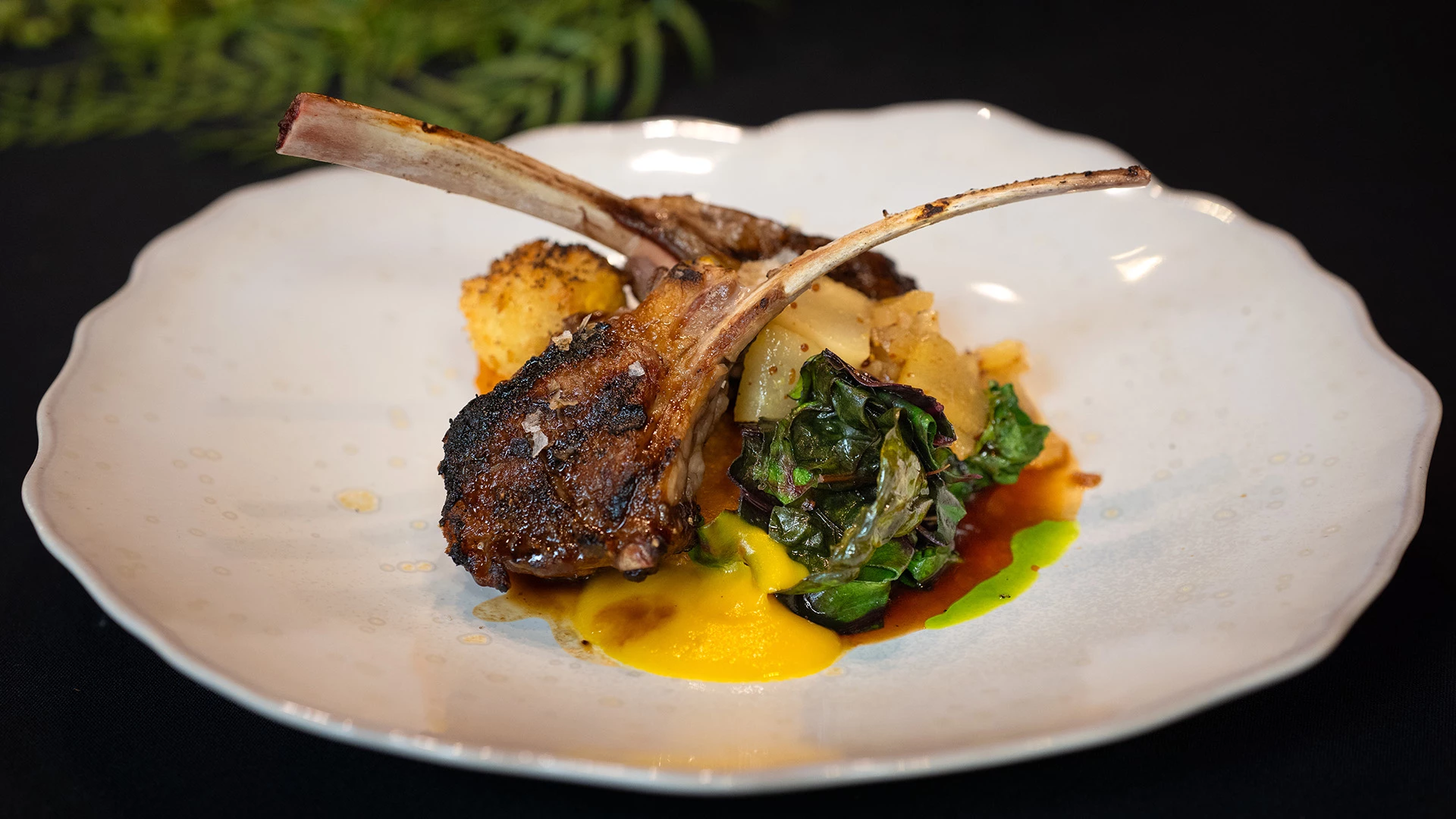 a plate of food on a black surface