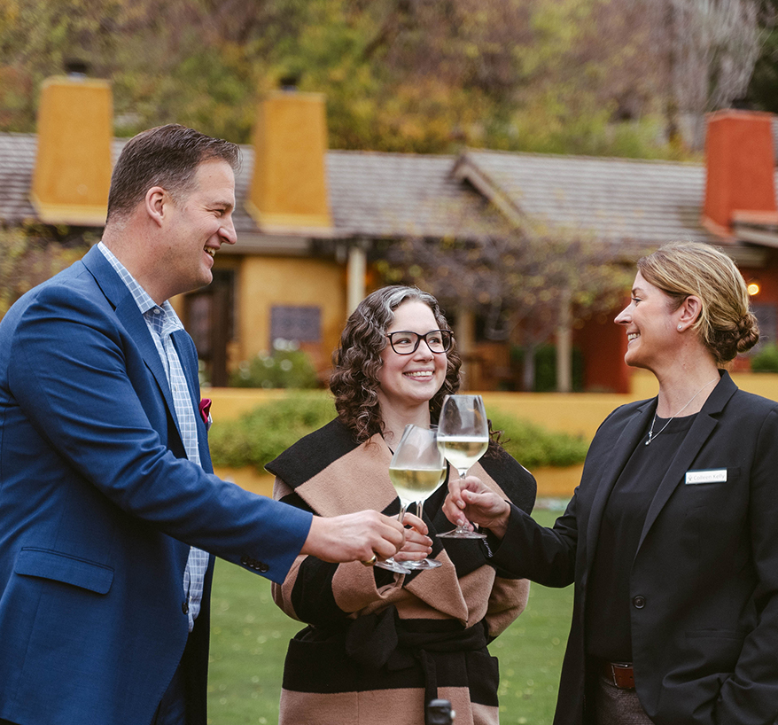a group of people holding wine glasses