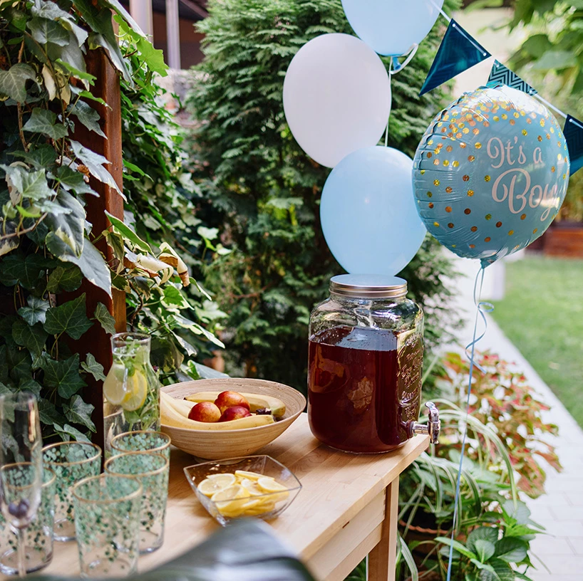 a table with a drink and balloons