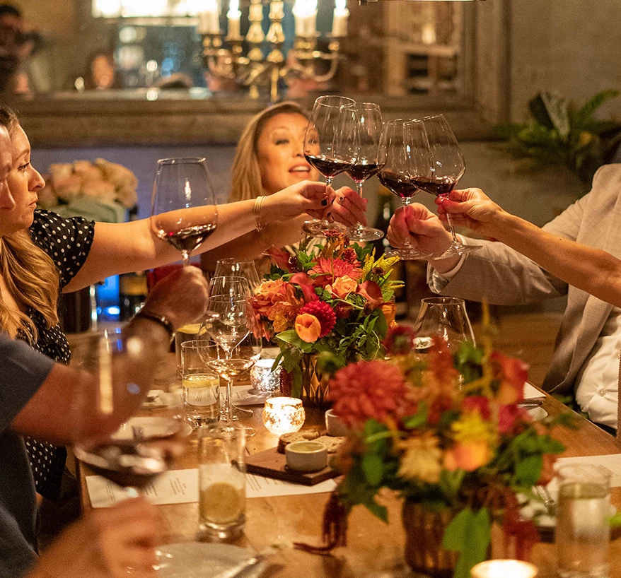 a group of people clinking glasses at a table