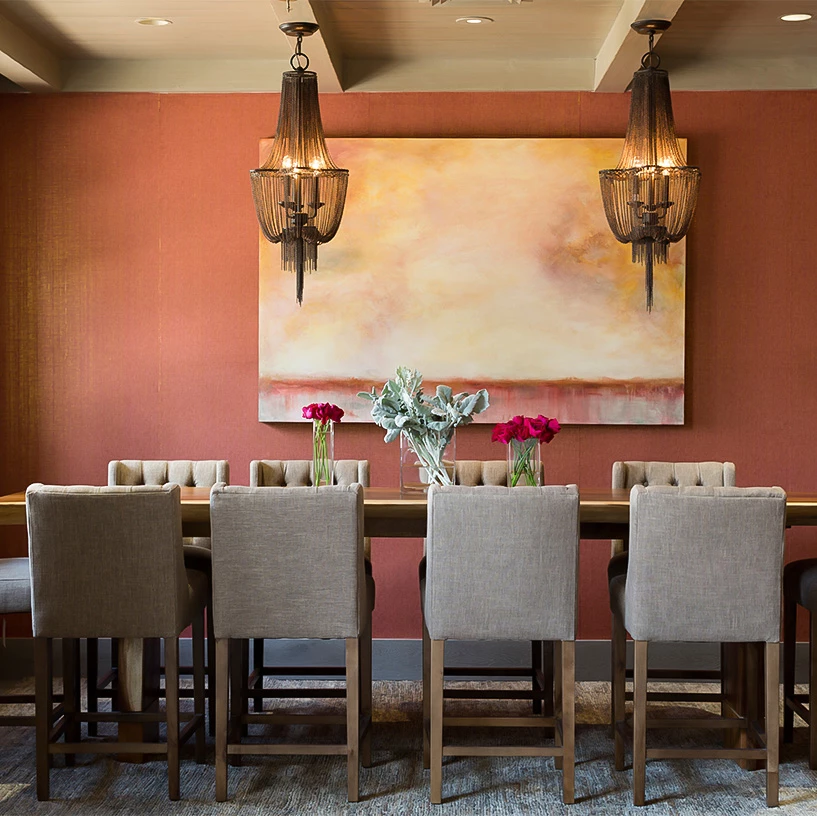 a dining room with a table and chairs
