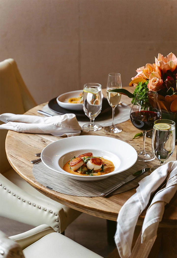 a table with food and wine glasses