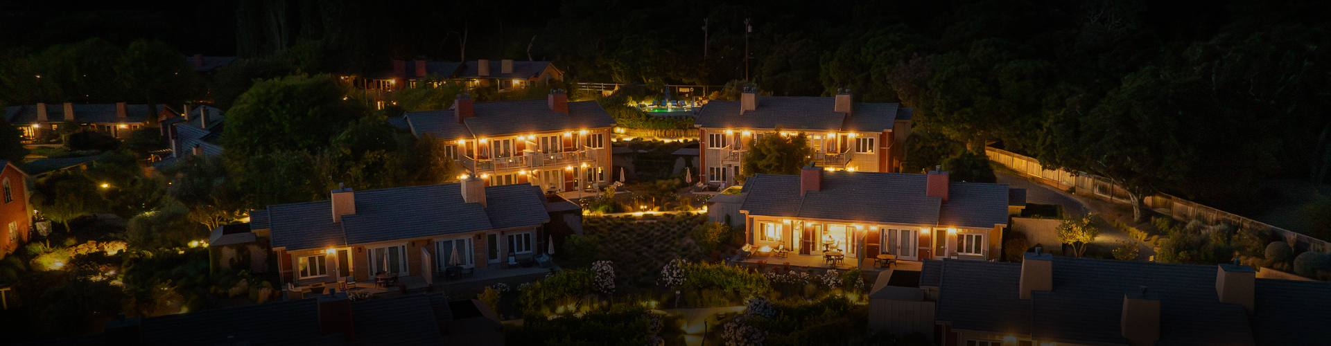 a group of houses with lights at night
